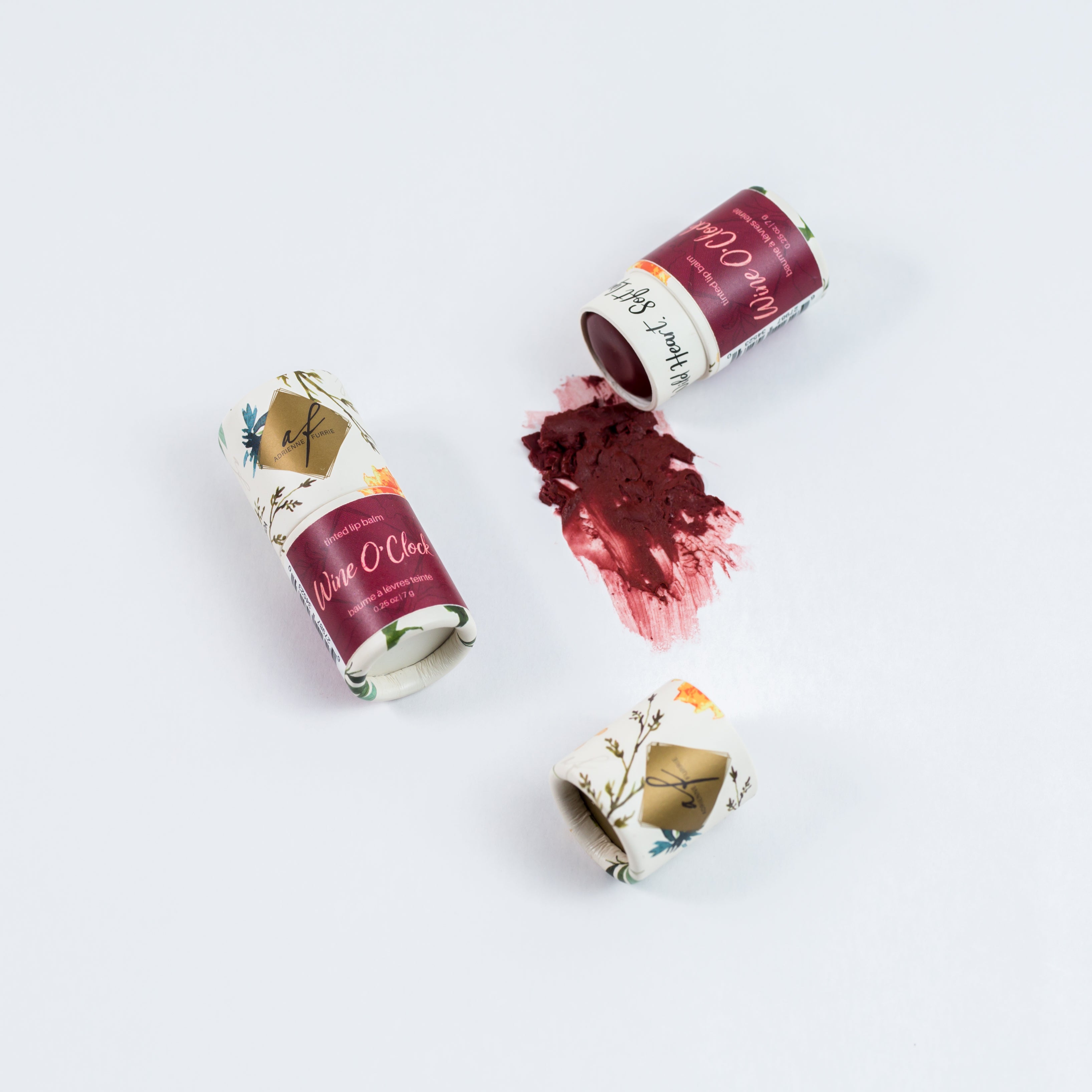individual natural tinted lip balm showing packaging and colour #color_Wine O'Clock - Plummy red brown with no pearlescence