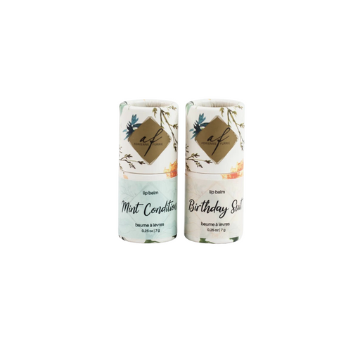 Two all-natural lip balms with beeswax, with floral patterns and labels 'Mint Condition' and 'Birthday Suit' respectively, against a white background.