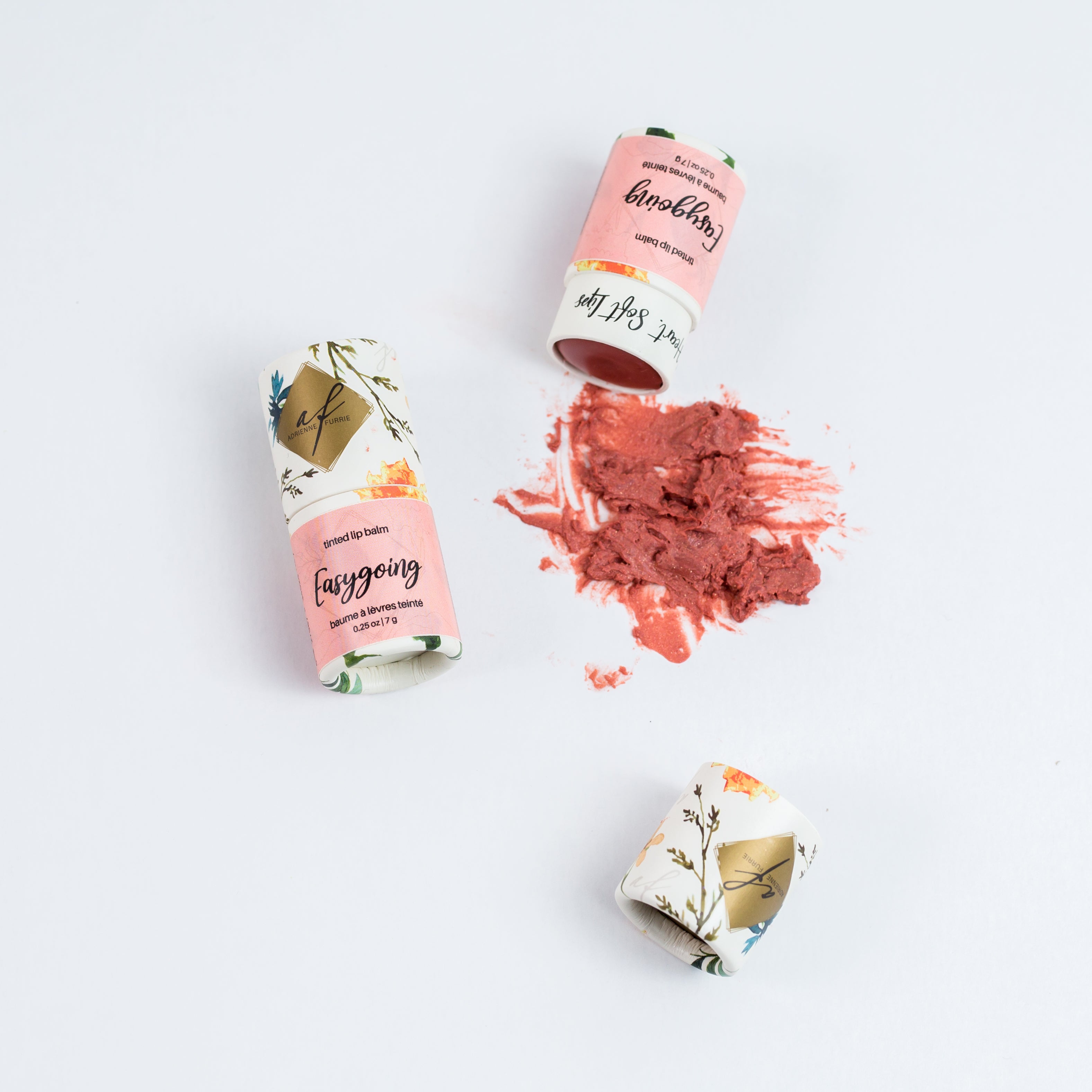 individual natural tinted lip balm showing packaging and colour #color_Easygoing - Perfect pinky nude with a subtle flash of pearlescent gold
