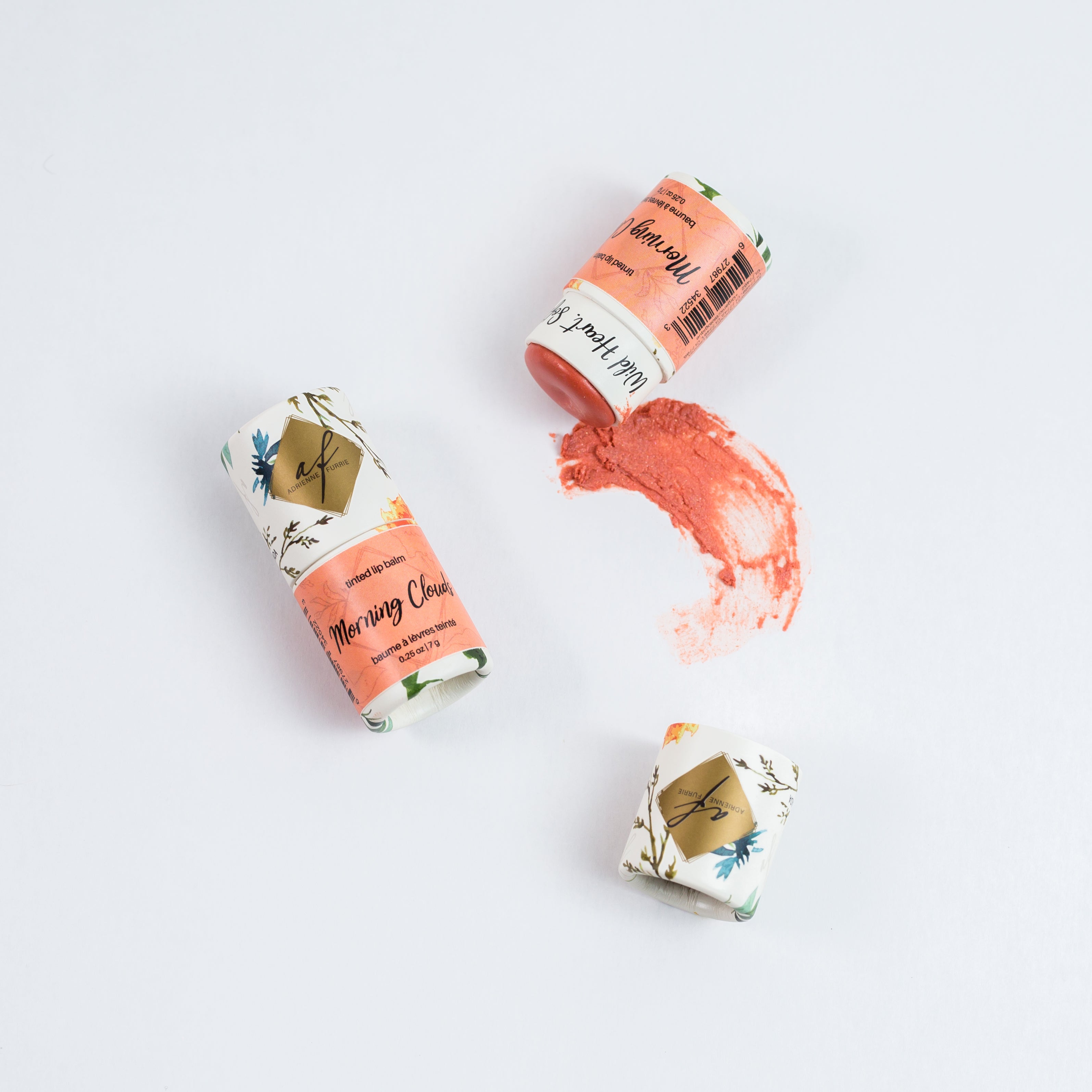 individual natural tinted lip balm showing packaging and colour #color_Morning Clouds - Soft peach with a subtle flash of pearlescent gold and red